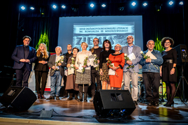 Zdjęcie laureatów, organizatorów i partnera podczas gali, na scenie sali widowiskowej Łosickiego Domu Kultury.
